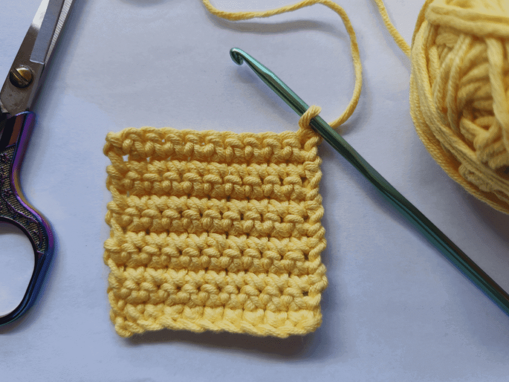 Step by step tutorial showing how to make a single crochet stitch for beginners